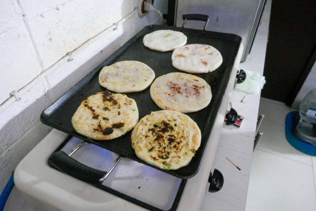 How pupusas look when cooking on a griddle.
