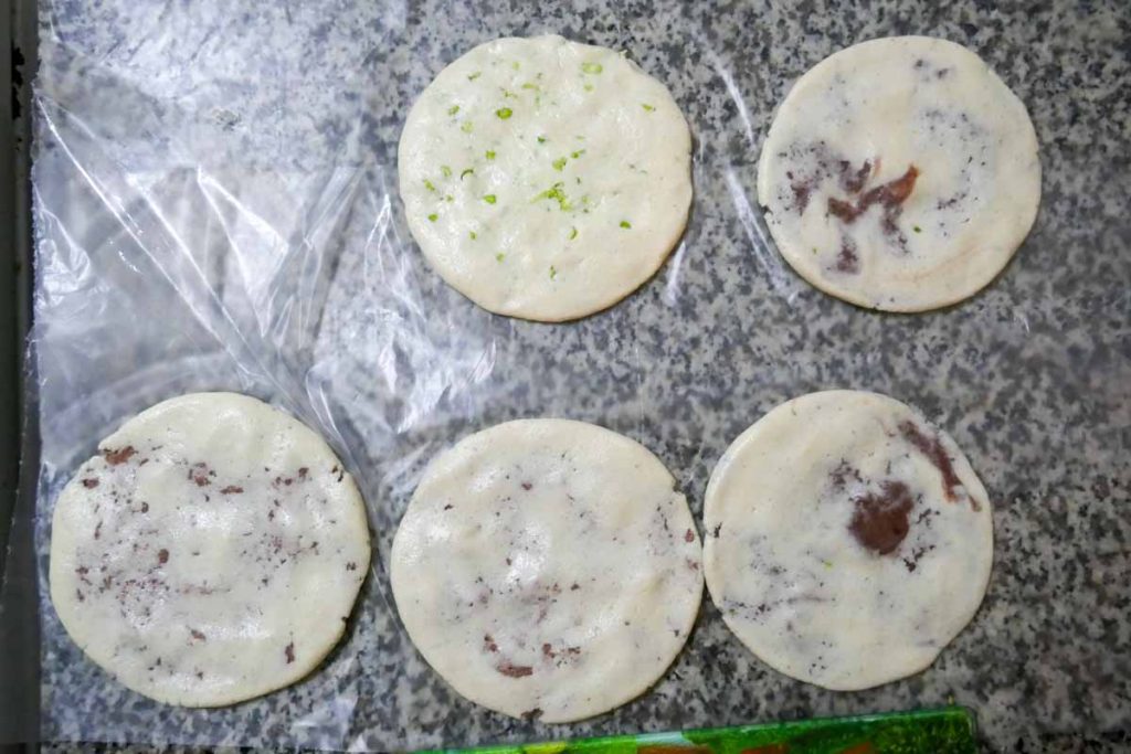 Lay out your pupusas on film to keep them seperate before cooking.