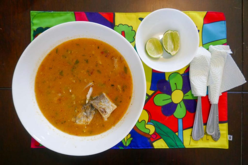 El Salvador traditional food Sopa De Pescado (fish soup) served with limes.
