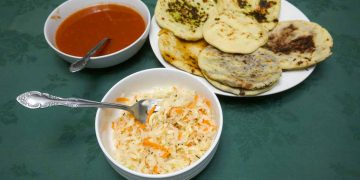 How to make pupusas recipe. The image shows cooked pupusas curtido and salsa roja