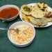 How to make pupusas recipe. The image shows cooked pupusas curtido and salsa roja