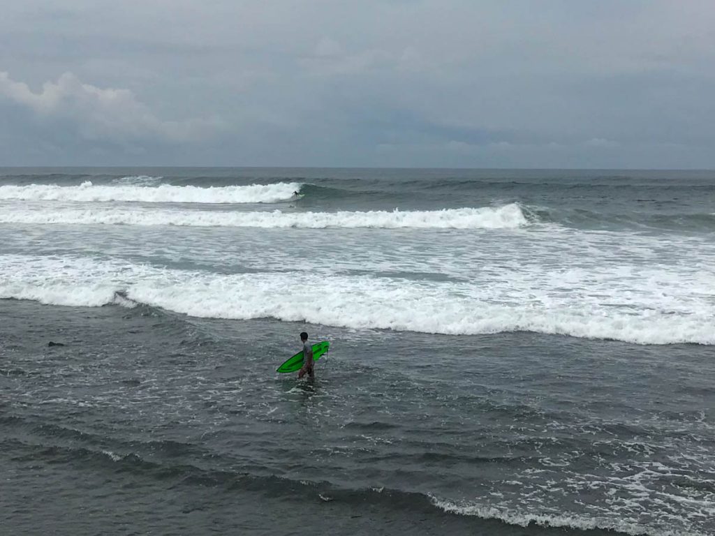 Surf spot La Bocana in El Salvador. Surfer surfing large wave left.