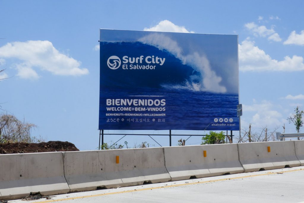 Surfing El Salvador. Surf City advertising billboard on the road to the beach from San Salvador.
